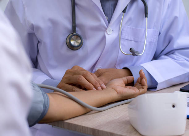 istock Doctor taking pulse rate for female patient. 1328780124