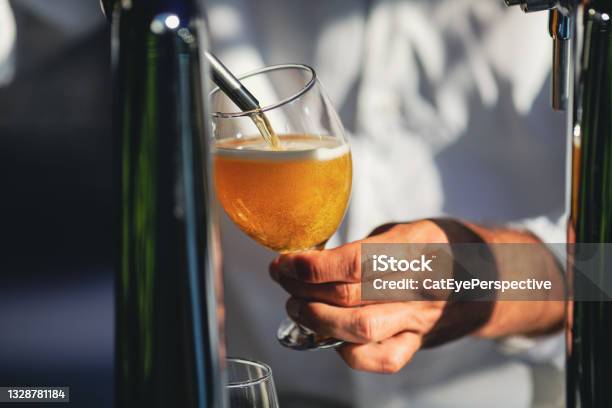 Shallow Depth Of Field Image With A Man Pouring Craft Beer From A Dispenser Into A Glass Stock Photo - Download Image Now