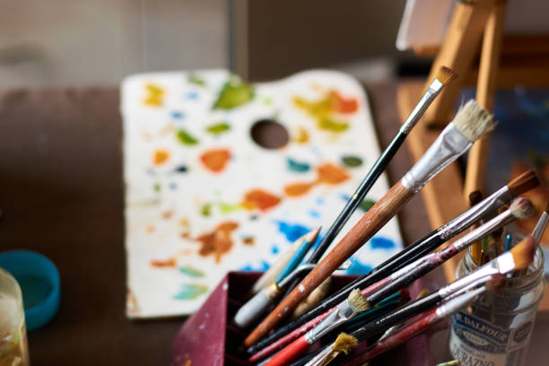 istock Table with brushes and canvas in an art workshop. Background. 1328782426