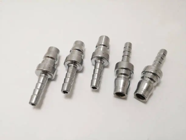 Photo of Plug quick coupler isolated steel.  Pneumatic Quick coupling