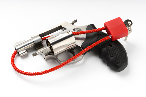 Locked disarmed and secured revolver gun on white background