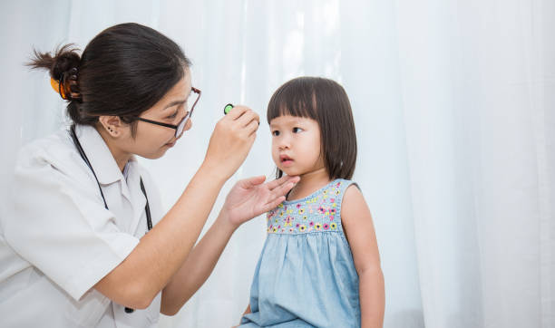 Asian doctor woman examine eyes of little asian girl in the clinic.  Senior looks in instrument for checking eyes at ophthalmologist. Health care and medical for young toddler kid concept. Asian doctor woman examine eyes of little asian girl in the clinic.  Senior looks in instrument for checking eyes at ophthalmologist. Health care and medical for young toddler kid concept. korean baby stock pictures, royalty-free photos & images