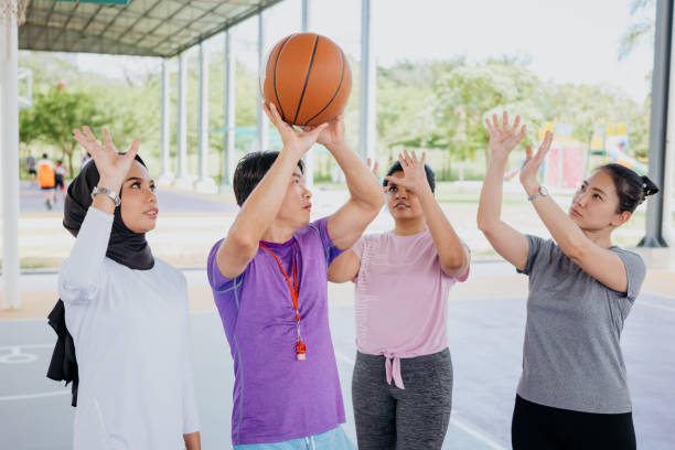 istock Asian basketball coach explaining techniques to his team members 1328790135