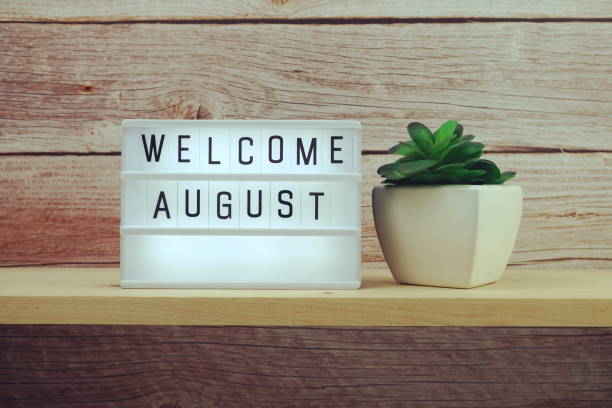 istock Welcome August word in light box on wooden shelves background 1328790357