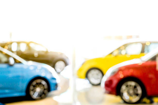 istock blurred colorful modern car in showroom 1328791200