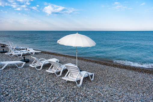 Idyllic morning on the beach: sun loungers and sun umbrellas in the resort village of Nebug, Krasnodar Territory, Russia