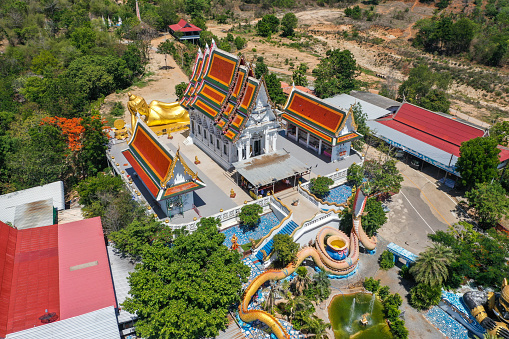 Wat Khao Sung Chaem Fa temple with giant snake and reclining gold buddha, in Kanchanaburi, Thailand, south east asia