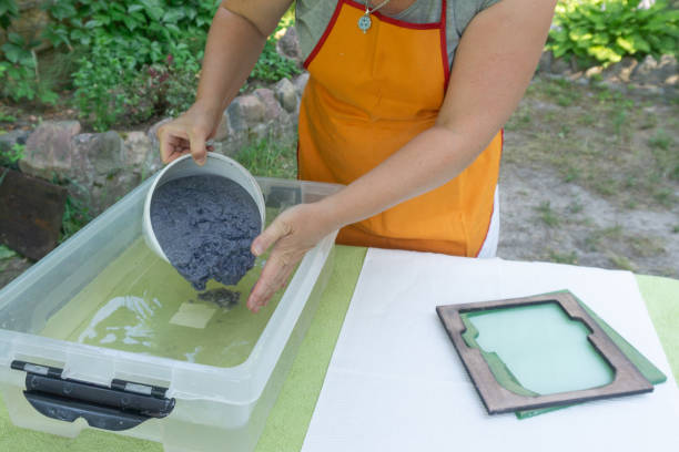 production of handmade paper sheets from waste paper at home. frames for pouring paper. secondary production, arts and crafts concept. - secondary action imagens e fotografias de stock