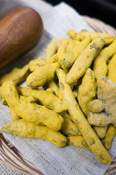 istock Yellow turmeric powder and dry roots on white background. 1328797272