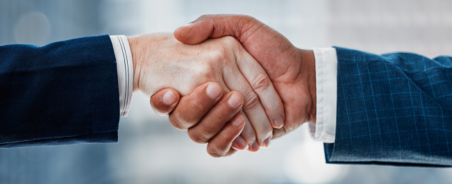 Business people, support and shaking hands for agreement, meeting and b2b deal for success, welcome and reward. Closeup, handshake and introduction of partnership, integration and recruitment offer