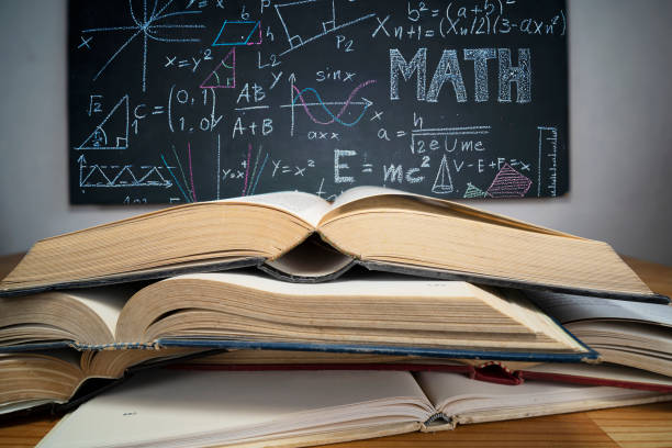 istock stack of books on the blackboard background 1328798598