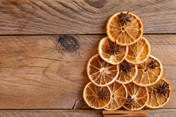 istock Christmas tree made from anise star seeds, cinnamon sticks, orange dry, with copy space background. 1328800066