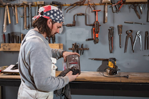 istock Male carpenter working on old wood in a retro vintage workshop. 1328802280