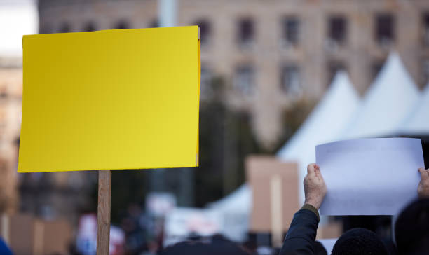 istock Protesters holding placards and signs on the streets. 1328802920