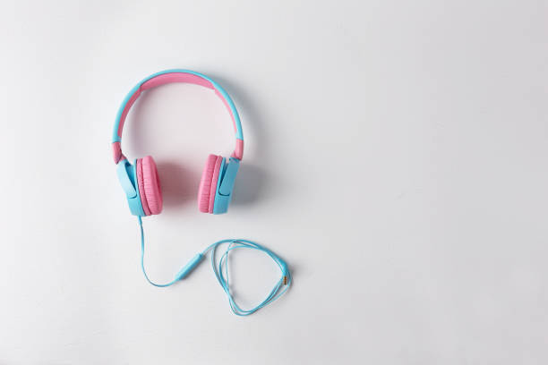 istock Pink and blue headphones on a white background 1328802936