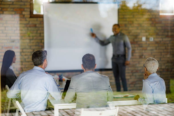istock Back view of entrepreneurs on a presentation in the office. 1328805327
