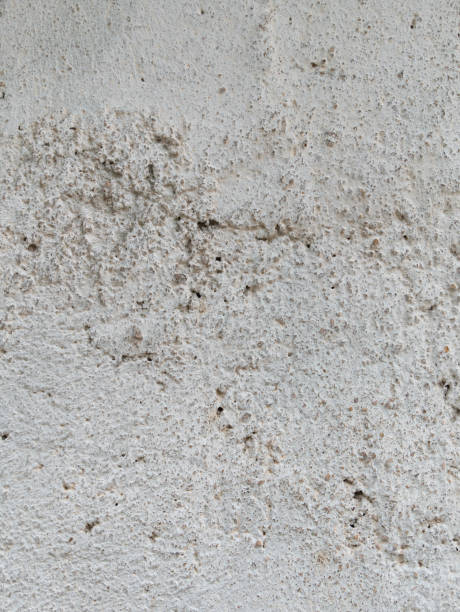 istock Gray concrete with plaster light painted wall monochrome background. Black and white stone house limestone fence texture 1328808955