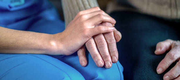 istock Young woman's hands hold grandmother's hands, an elderly patient. 1328809623