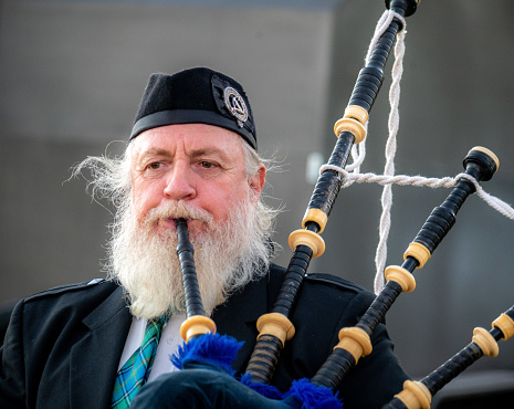 Lismore,NSW- June 19th, 2021\nScottish piper marches in a parade to celebrate the Winter Solstice.