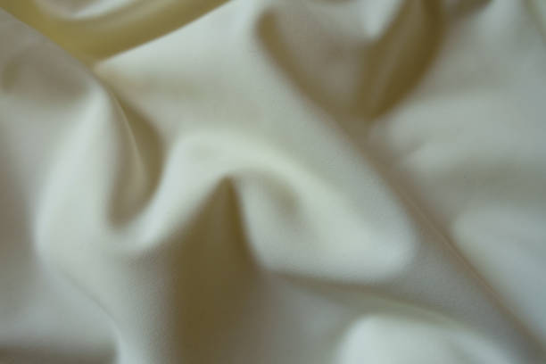 istock Thin ivory viscose and polyester jersey fabric with soft folds 1328812124