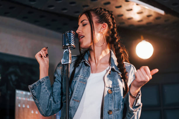 istock Young beautiful female performer rehearsing in a recording studio 1328815836