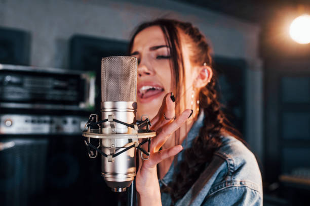istock Young beautiful female performer rehearsing in a recording studio 1328815904