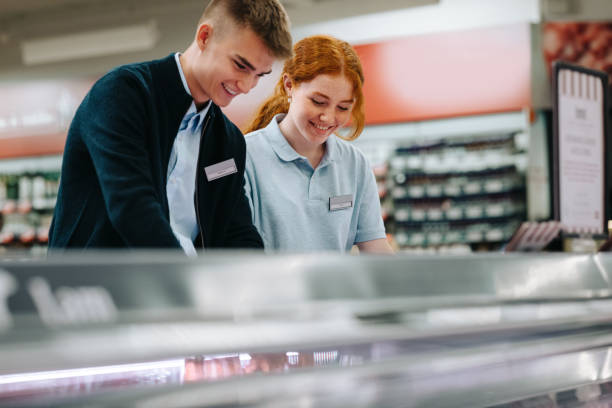 istock Trainee workers working together in supermarket 1328815946