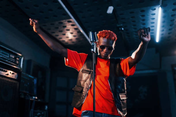 istock Young african american performer rehearsing in a recording studio 1328816064