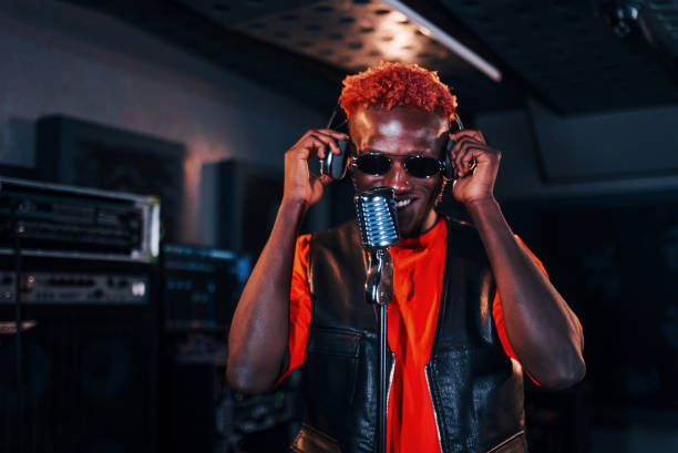 istock Young african american performer rehearsing in a recording studio 1328816107