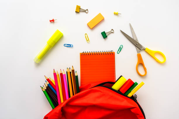 istock A red school bag with colored pencils, scissors and a notepad 1328816490