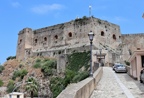Scilla, Calabria, Italy - June 13, 2021: Fortification dating back to the 5th century BC, transformed into a baronial residence by the Ruffo family in 1533, acquired to state property in 1808 and renovated in the 20th century