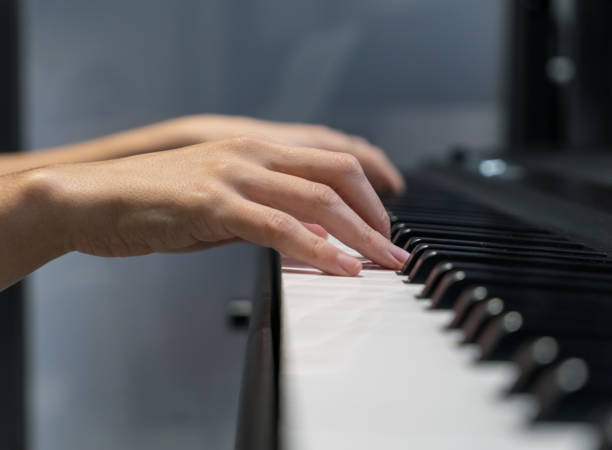 istock Woman playing a song on her piano 1328817703
