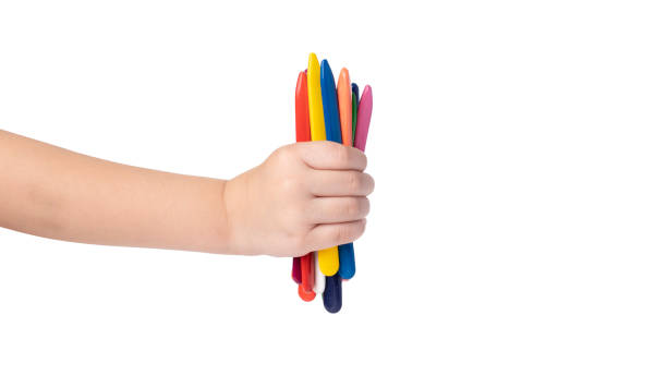 istock child holding multicolored pencils isolated on white background. copy space template. wax crayons 1328818223