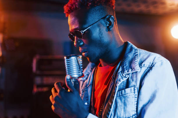 istock Young african american performer rehearsing in a recording studio 1328818939