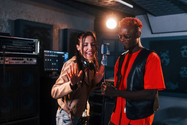 istock Two multi ethnic friends have a vocal practice in the studio together 1328818983