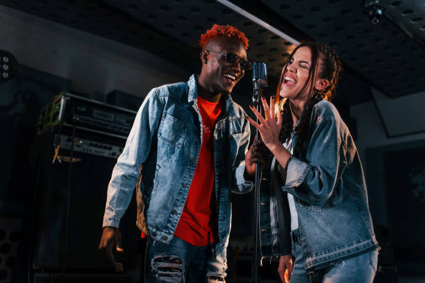 istock Two multi ethnic friends have a vocal practice in the studio together 1328819009