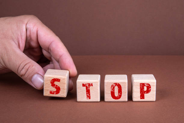 istock STOP. Wooden blocks on a brown background 1328822936