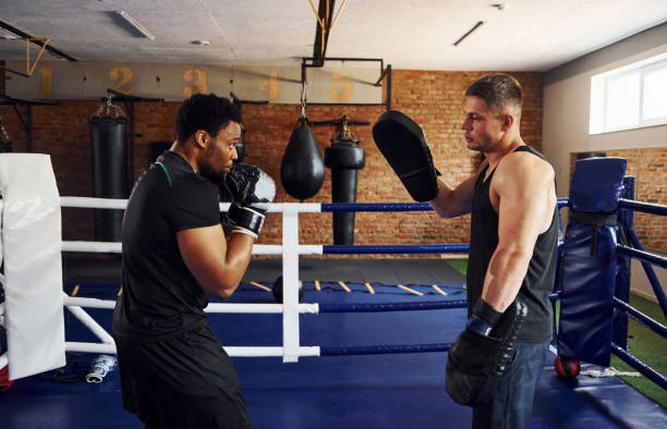 istock Having boxing practive. African american man with white guy have workout day in gym 1328826055