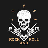 istock Rock-n-Roll music grunge typography for t-shirt. Clothes design with skeleton hands and skull. Graphics for clothes, print, apparel. Vector 1328826946