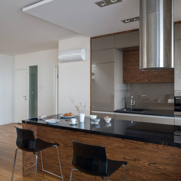 istock Kitchen island with black countertop in small kitchen 1328829819