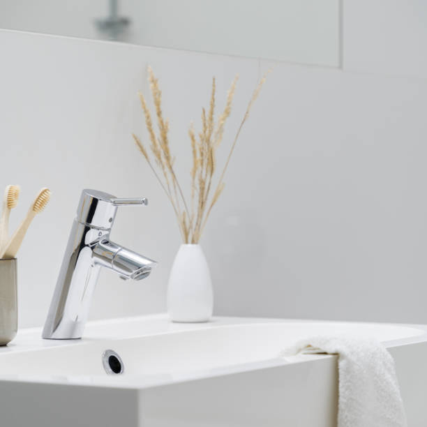 istock Close-up on silver tap in bathroom washbasin 1328829839
