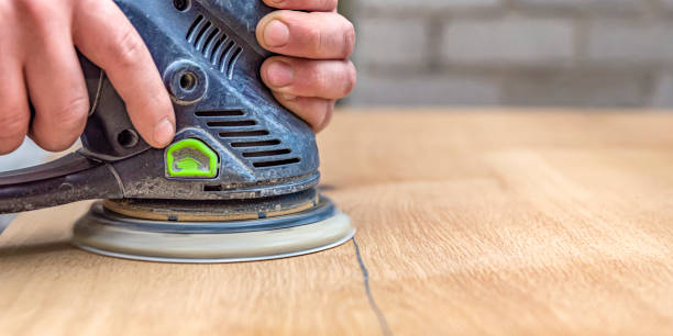 istock A carpenter works in a workshop. Joiner's grinders, furniture manufacturing. A carpenter is grinding a wooden part with an electric sander. place to insert text 1328830399