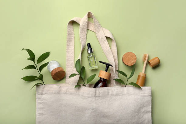 istock Bag with eco friendly products on green background, flat lay 1328831257