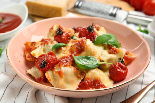 istock Tasty ravioli with tomato sauce served on table, closeup 1328831286