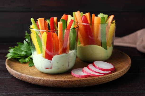 istock Fresh raw vegetable sticks with sauce on wooden table 1328831728