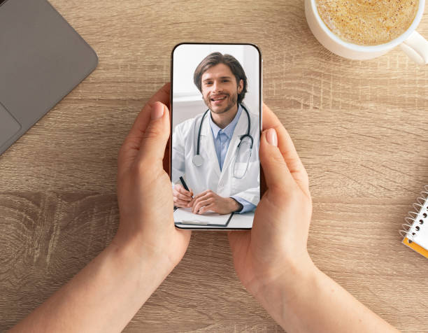 istock Woman having video call with doctor while working at office 1328831948