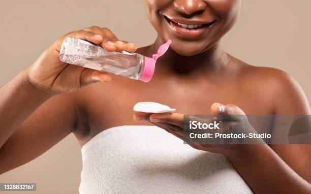 Beauty Routine Closeup Of Black Female Using Micellar Water For Makeup Removing Stock Photo - Download Image Now