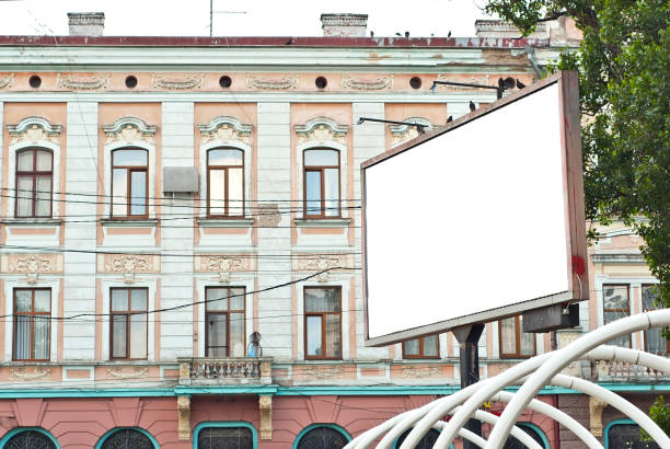 istock Blank billboard on house background. Old architecture in the background. Copy space and space for text. Mockup for design. Blank template for advertising. 1328833056
