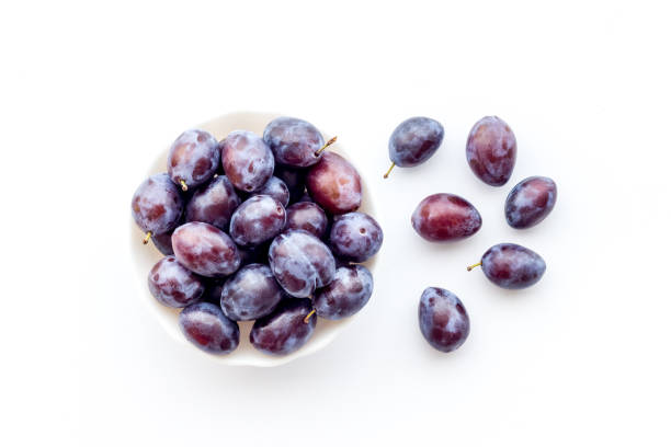 istock Food layout with plums in bowl with leaves. Top view 1328833100