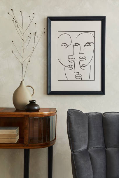 istock Stylish minimalistic composition of creative living room interior with mock up poster frame, dry flowers in vase, wooden commode and elegant personal accessories. Neutral beige wall. Template. 1328833775